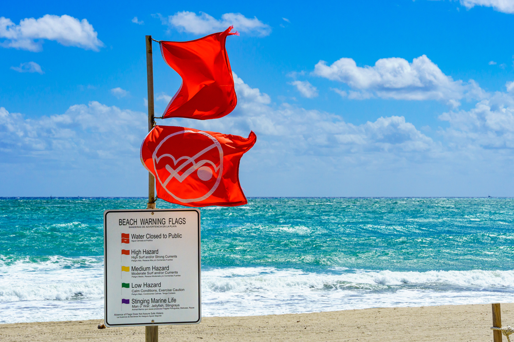 Of all mistakes to avoid in Florida, make sure to know the flags of the beach! Two red flags above bright blue water and tan sands indicates that this beach is closed due to high hazard risks. 