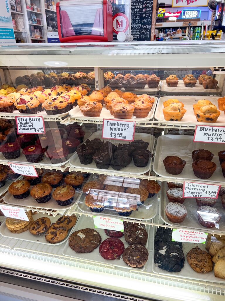 a case of pastries and muffins inside Modica Market