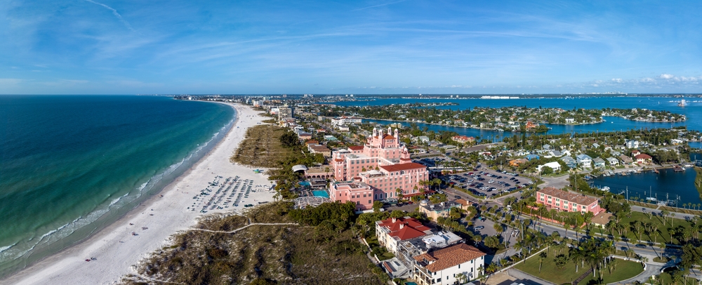 an Ariel view with the pink hotel Don Cesar sitting on St. Pete Beach one of the best beaches near Tampa, with overlooking town, white sand beach and water