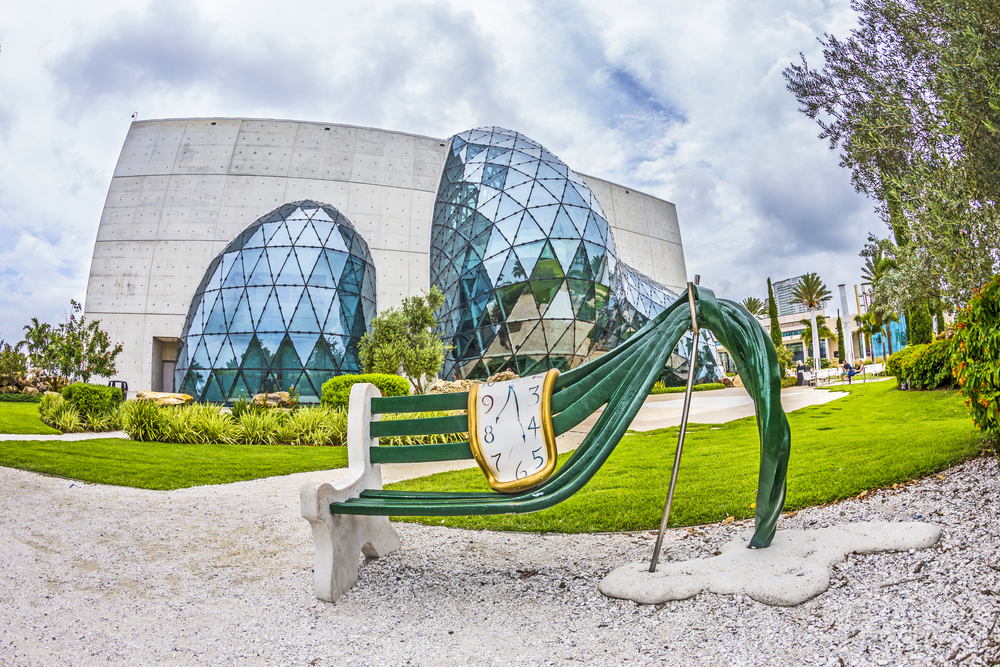 The Dali Museum in Tampa with its glass domes, concrete building, and clock Bench 