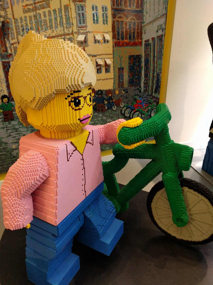 a lego statue of a woman and a bicycle built out of legos is one of the many types of things you can see at Legoland in Florida