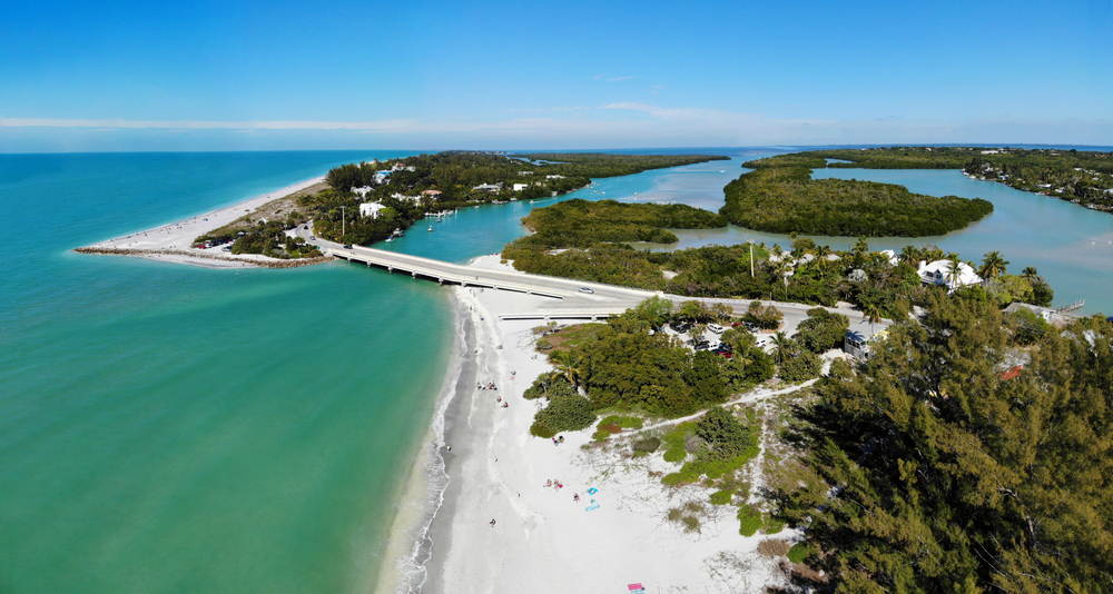 aerial photo of an islands that has white sandy beaches and a lot of trees, one of the best islands in florida 