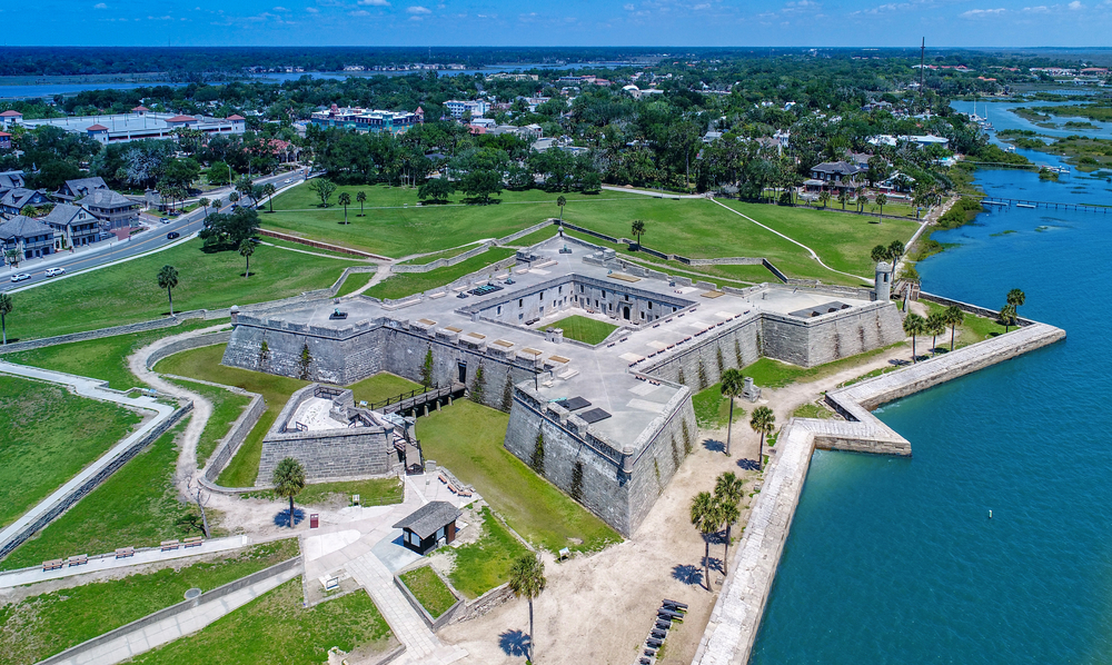 an Ariel view of the fort in St Augustine with the water and city int he background