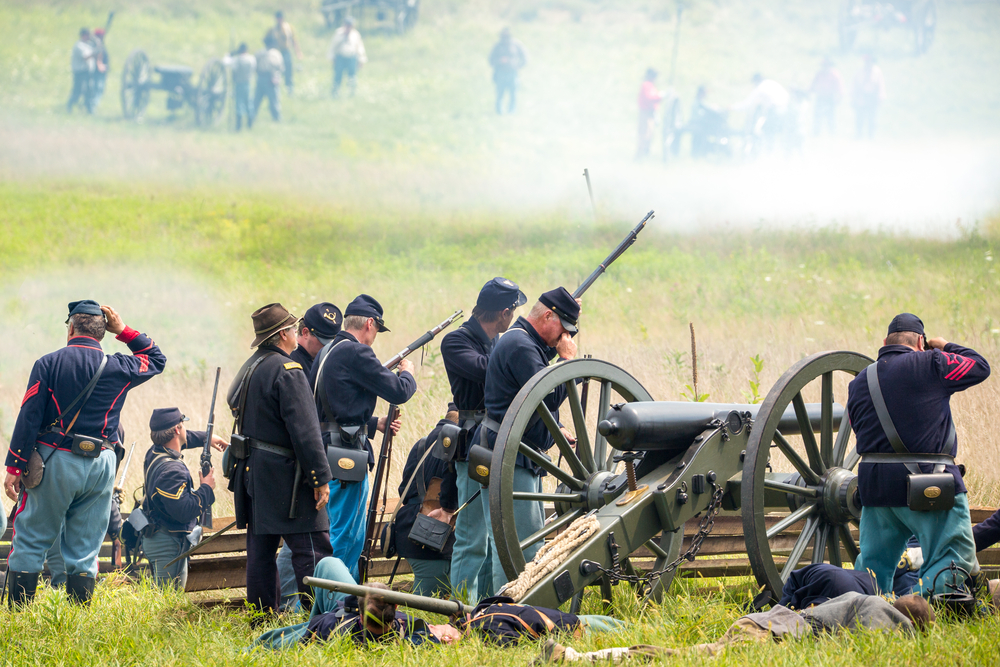 men reenacting a civil war battle with guns and cannons at a festival in florida 