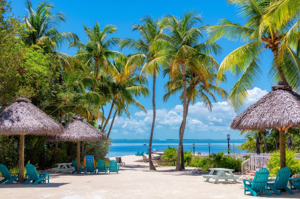 sandy beach, palm trees, and beach chairs, 5 day Key West Songwriters's festival is a music festival held in Key West Florida for country artist.