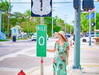 woman standing in green dress at mile 0 in key west