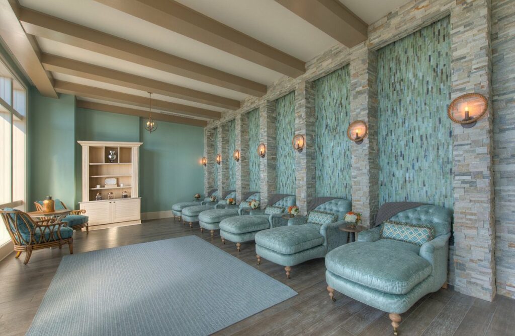 Spa chairs in a room. the room is blue and opulent. 