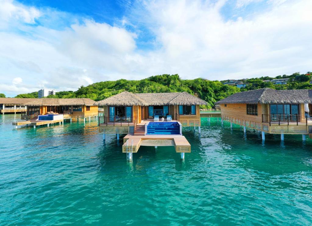 stunning large overwater bungalows near Florida with decks into the water and pools. 