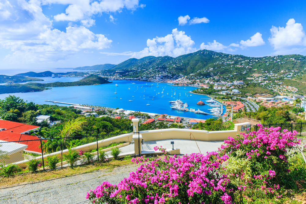 A shot of Charlotte Amalie shows rolling hills, blue waters, bright flowers in bloom during the spring. 