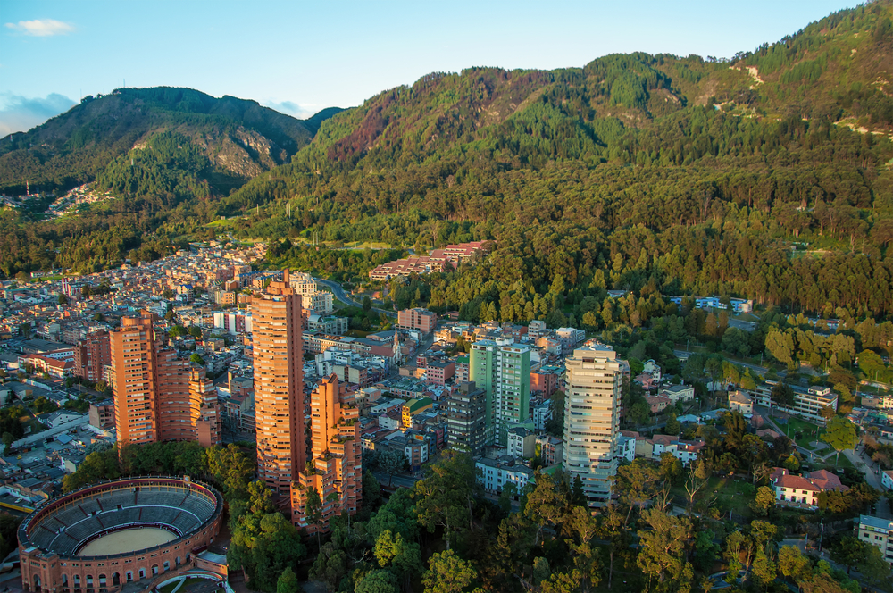 A view of the center of Bogota with the Andes in the background. The article is about cheapest places to fly from Florida.